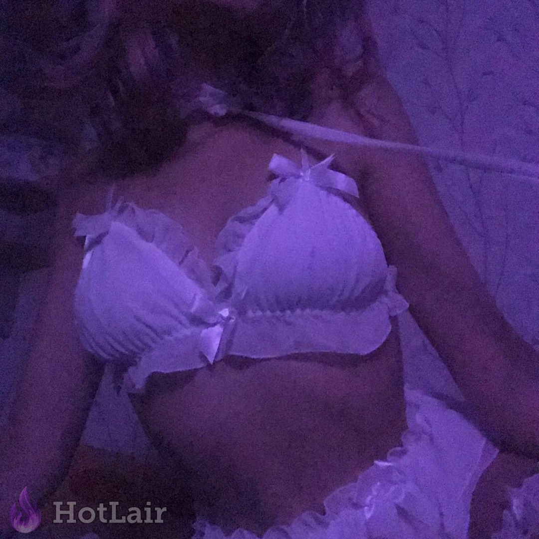 Beautiful girl posing in cute white ruffled lingerie bra