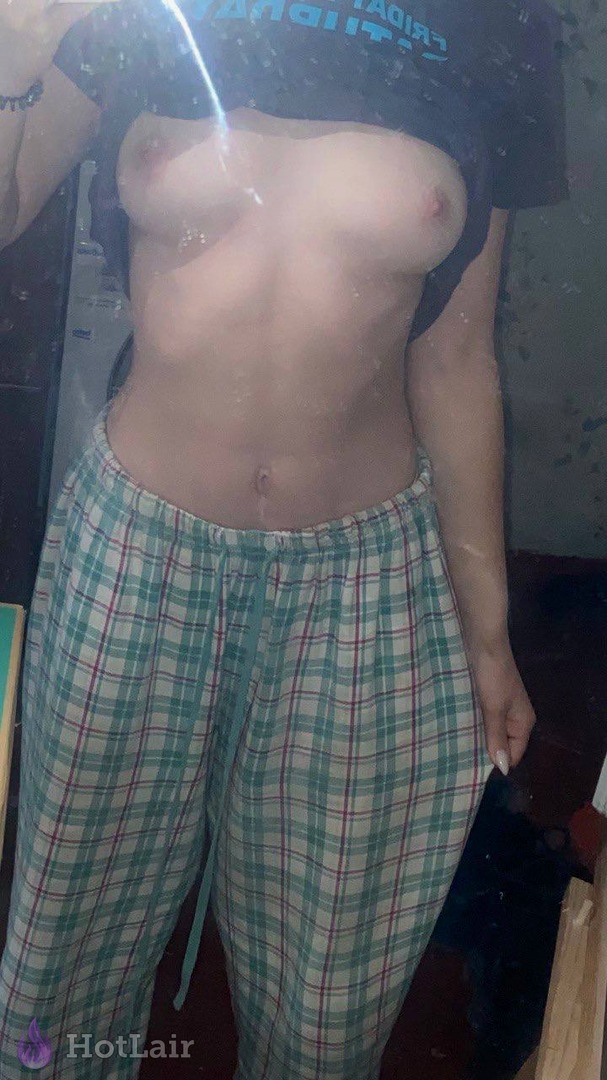 Topless girl lifting wet t-shirt to reveal breasts in plaid pants