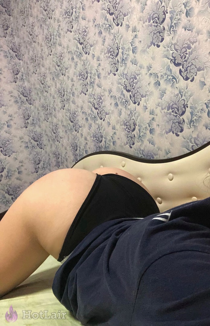 Sexy ass in black panties lying on bed