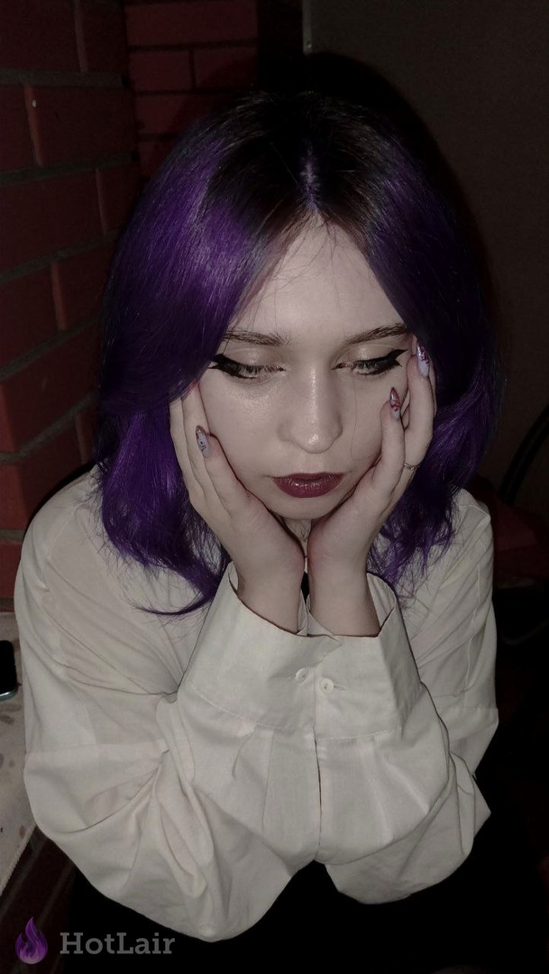 Purple-haired beauty in white shirt posing with hands on face, cute seductive look