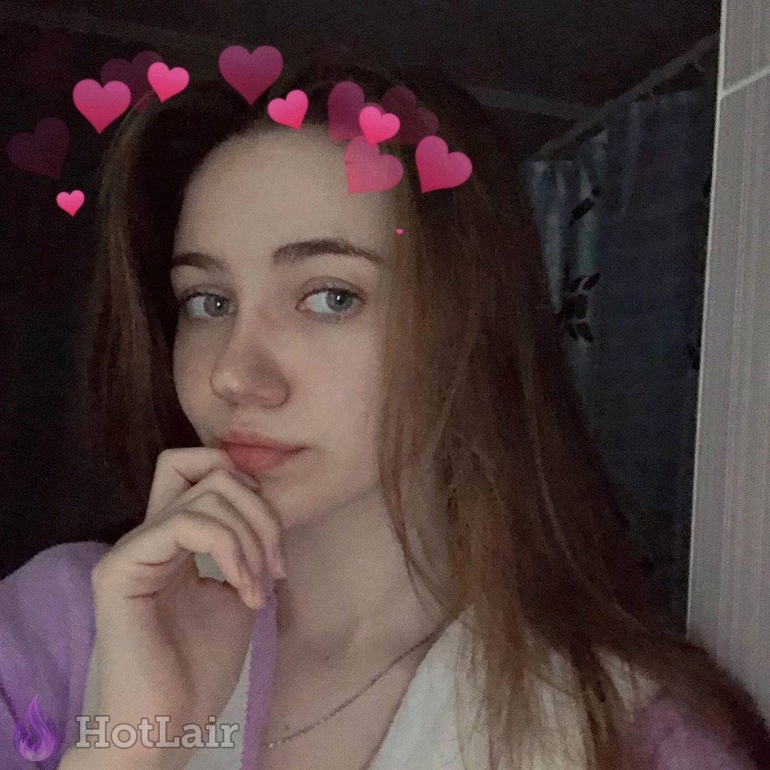 Cute brunette with blue eyes posing flirtatiously with pink heart filters overlay