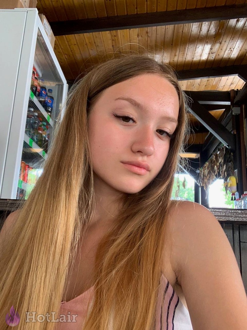 Gorgeous long-haired blonde taking natural outdoor selfie close-up