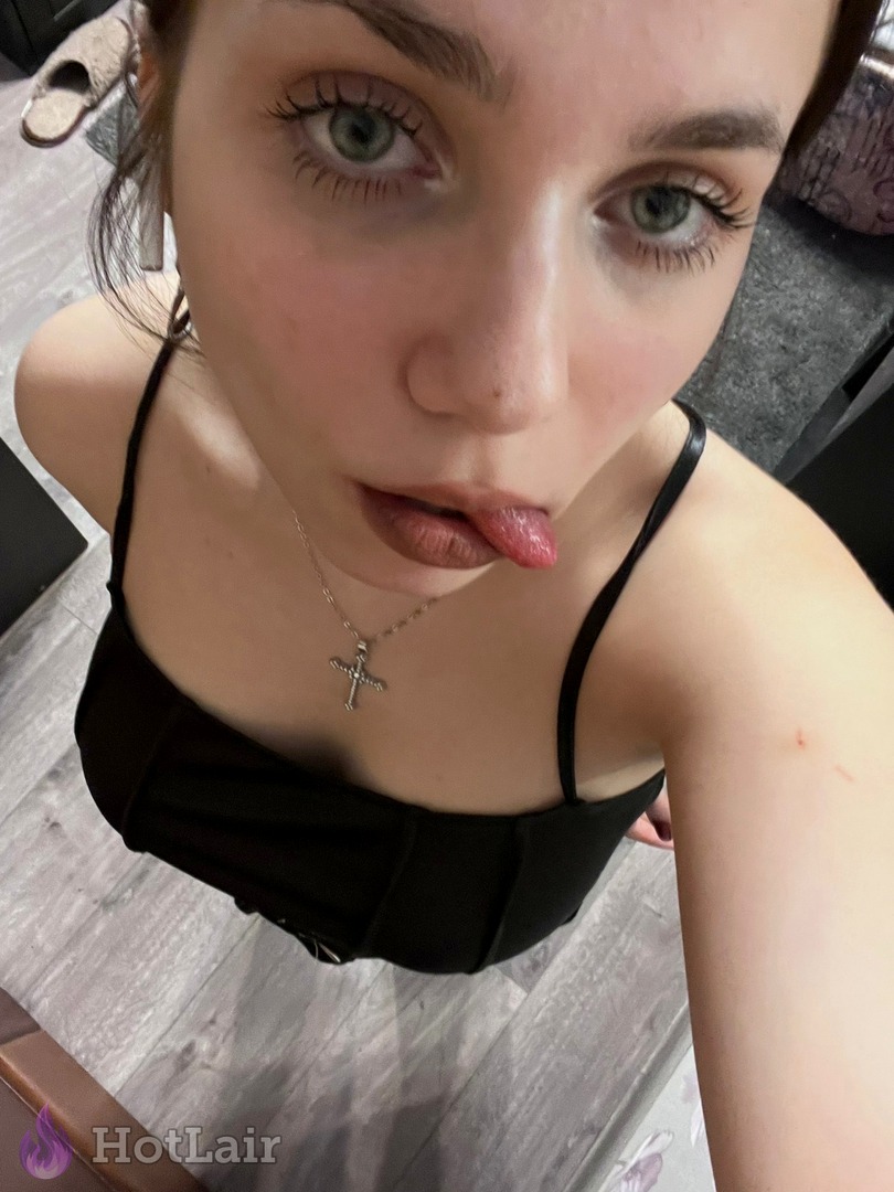 Playful brunette sticks tongue out in sexy close-up selfie