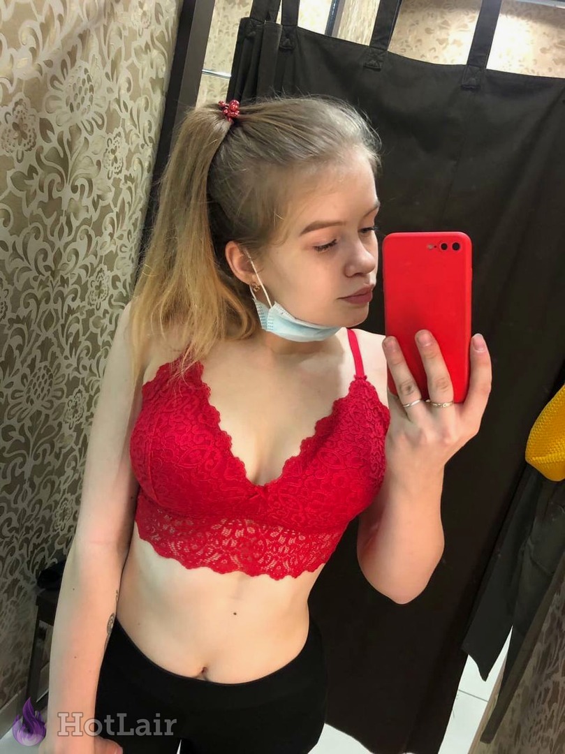 Cute blonde in red lace bra taking mirror selfie with red phone