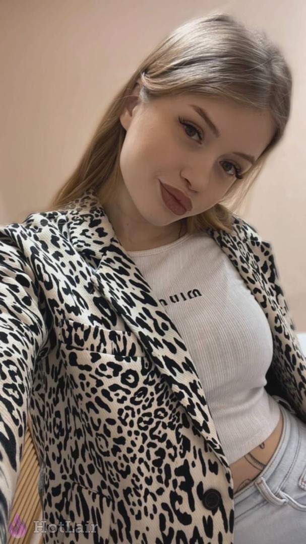 Stylish girl in leopard print blazer taking flirty selfie showing cleavage