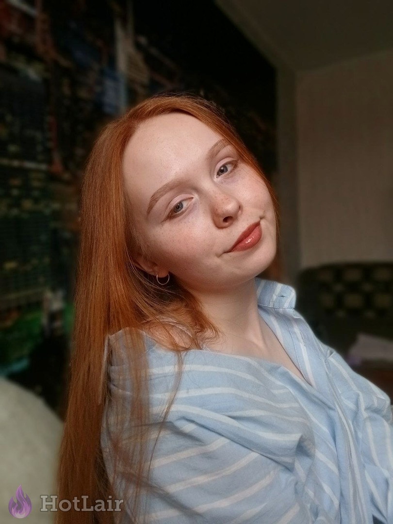 Stunning redhead with long hair and seductive gaze portrait